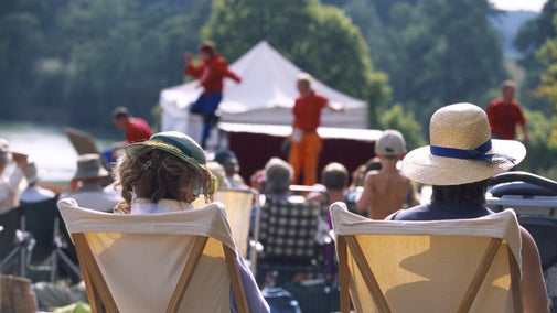 An audience enjoying an outdoor theatre performance